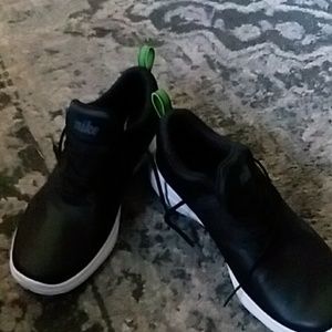 pair of Black Nike tennis shoes